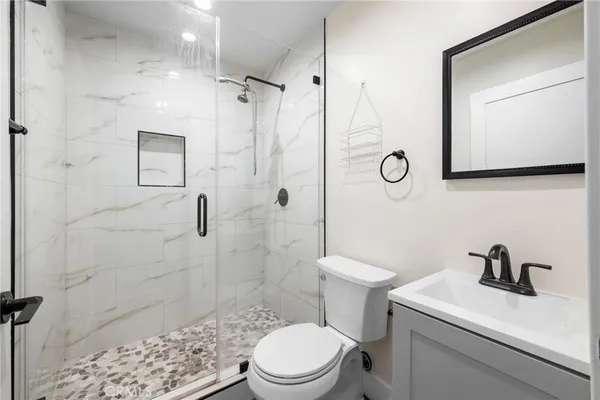 a bathroom with a toilet sink and shower