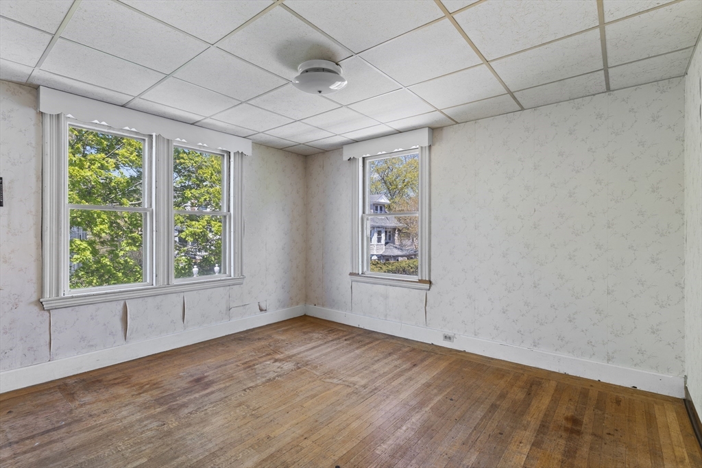 10 Alcott Street Boston, MA 02134 - Photo 14 of 36 an empty room with wooden floor and windows