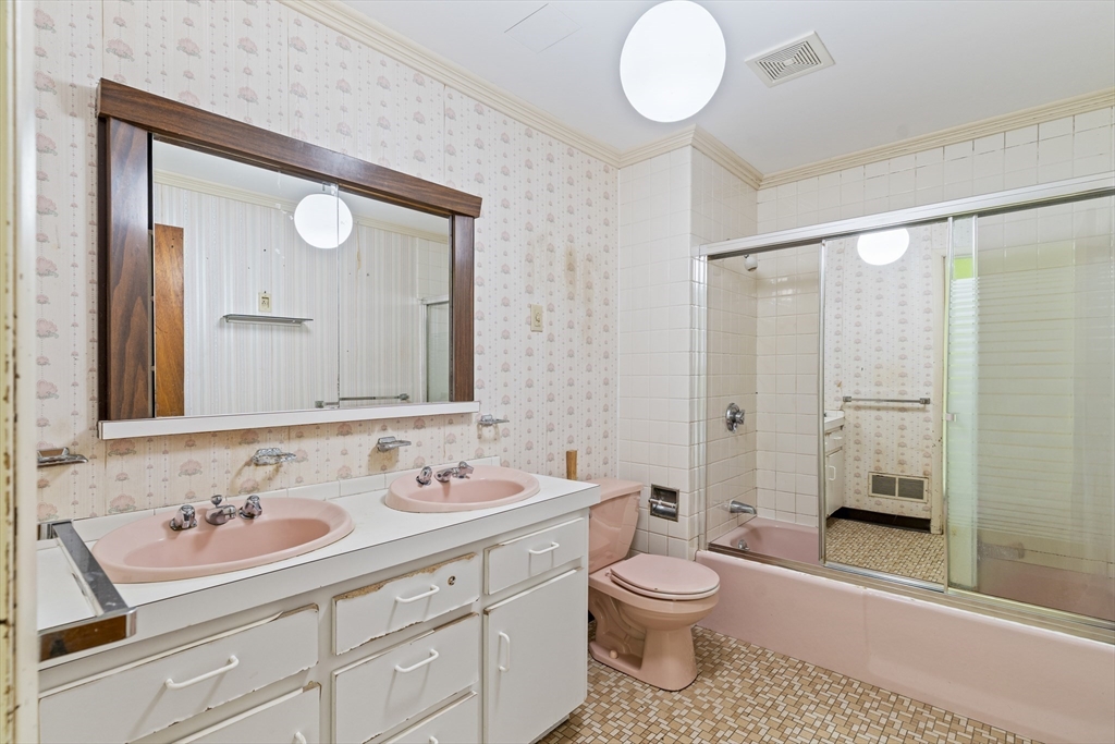 10 Alcott Street Boston, MA 02134 - Photo 17 of 36 a bathroom with a toilet sink and mirror