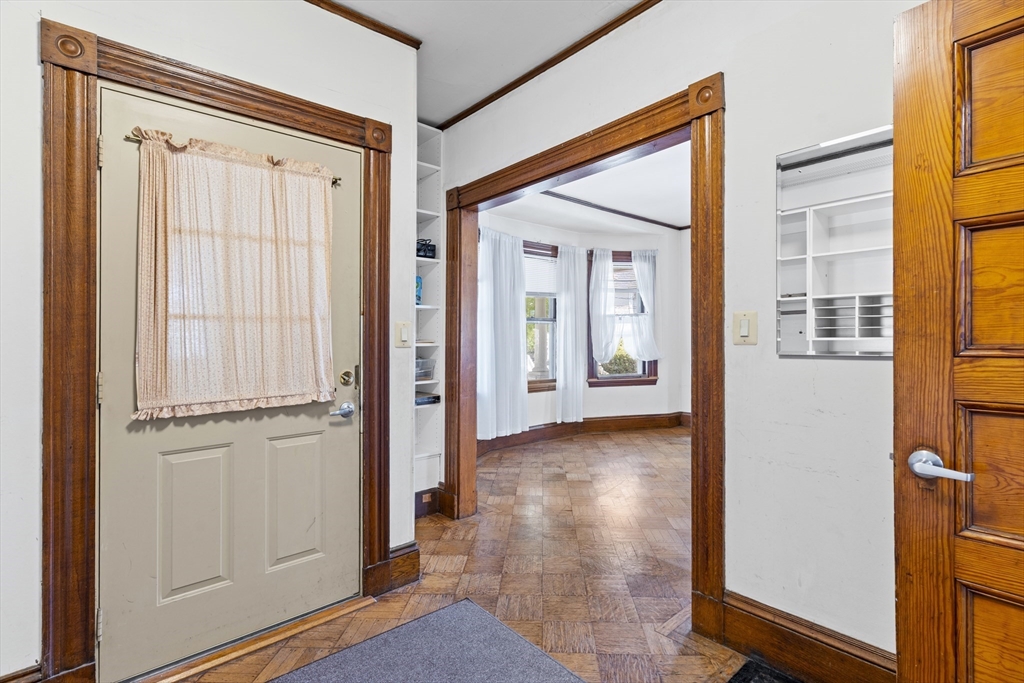 10 Alcott Street Boston, MA 02134 - Photo 2 of 36 a view of a hallway with wooden floor and windows