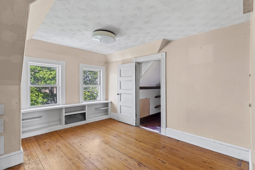 10 Alcott Street Boston, MA 02134 - Photo 21 of 36 wooden floor in an empty room with a window and wooden floor