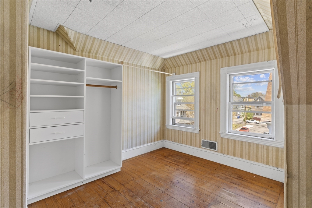 10 Alcott Street Boston, MA 02134 - Photo 24 of 36 a view of an empty room with wooden floor and a window