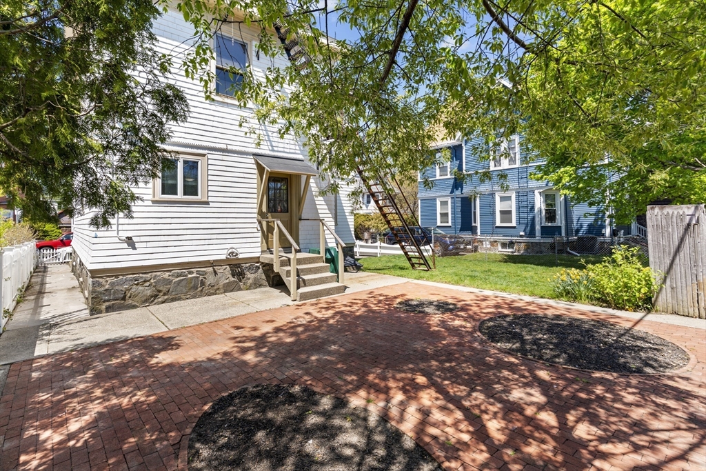 10 Alcott Street Boston, MA 02134 - Photo 29 of 36 a front view of a house with a yard