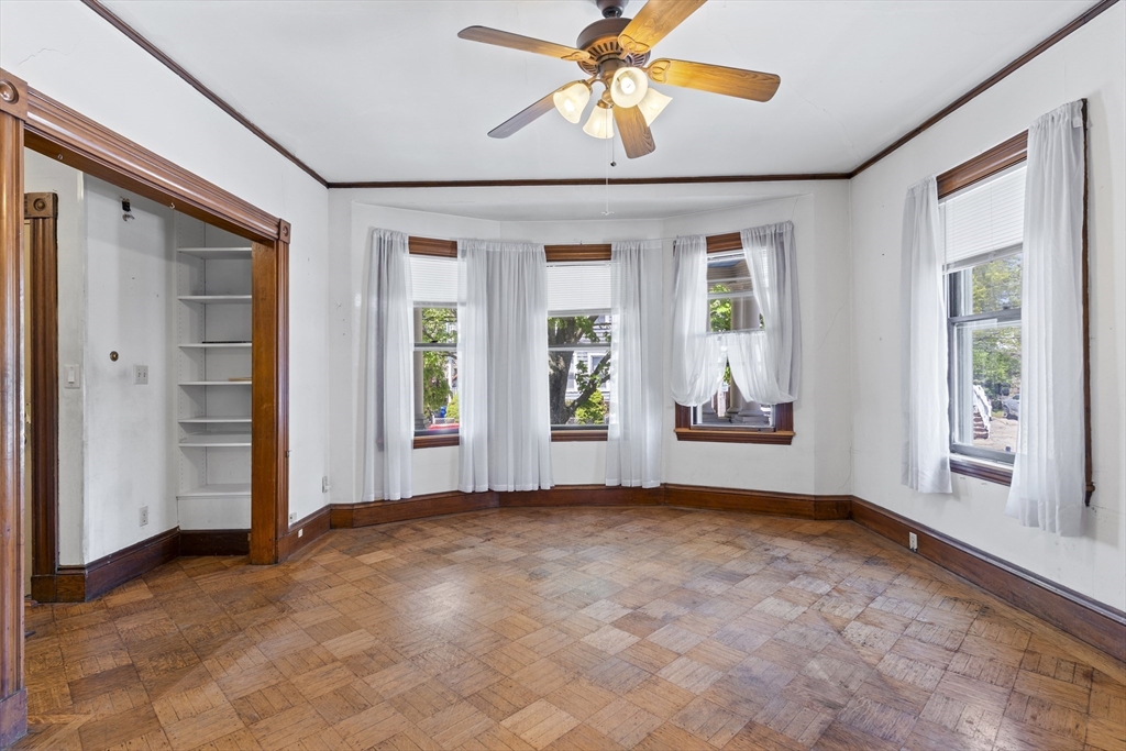 10 Alcott Street Boston, MA 02134 - Photo 4 of 36 en empty room with windows and chandelier fan