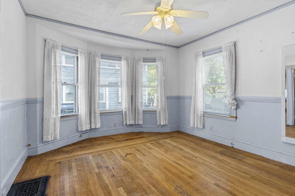 10 Alcott Street Boston, MA 02134 - Photo 6 of 36 a view of an empty room with wooden floor and a window