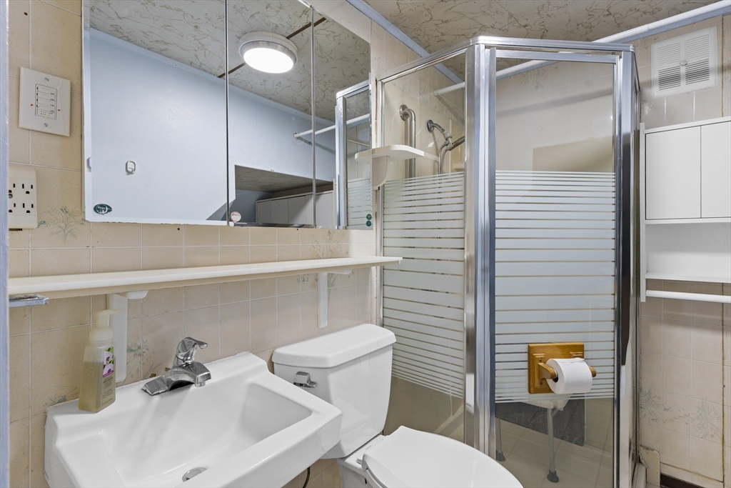 10 Alcott Street Boston, MA 02134 - Photo 8 of 36 a bathroom with a sink toilet and shower