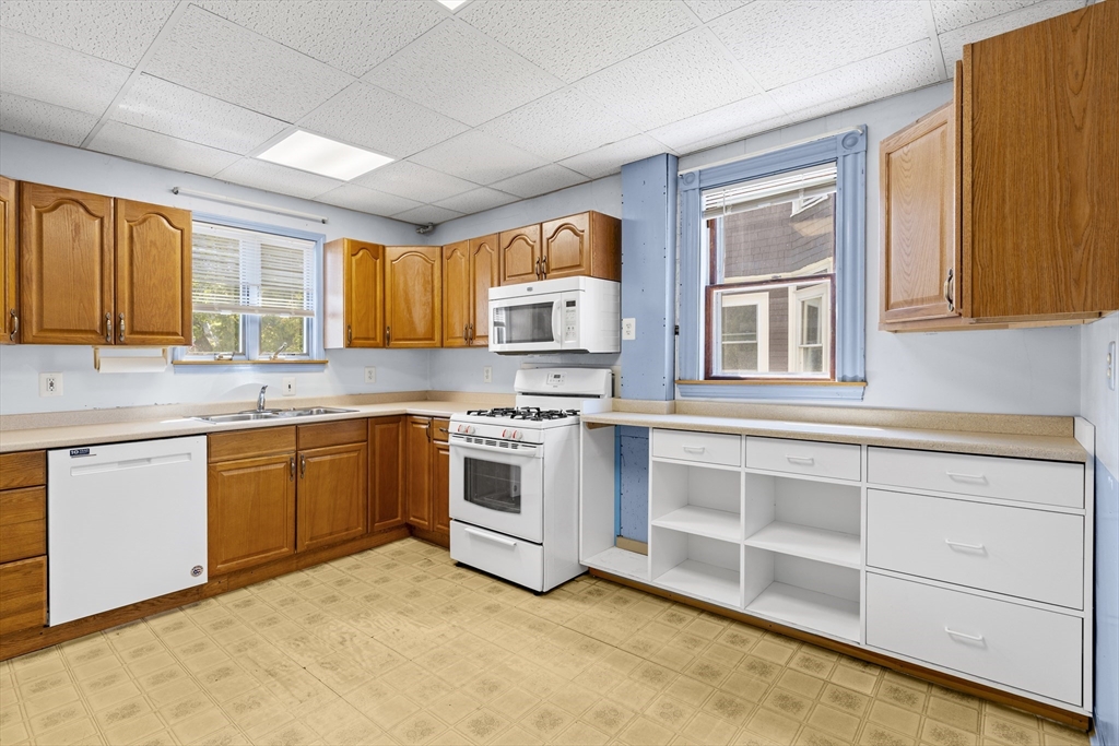 10 Alcott Street Boston, MA 02134 - Photo 9 of 36 a kitchen with granite countertop a stove a sink and a refrigerator