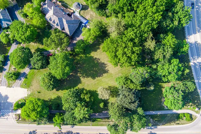 an aerial view of house with yard and outdoor seating