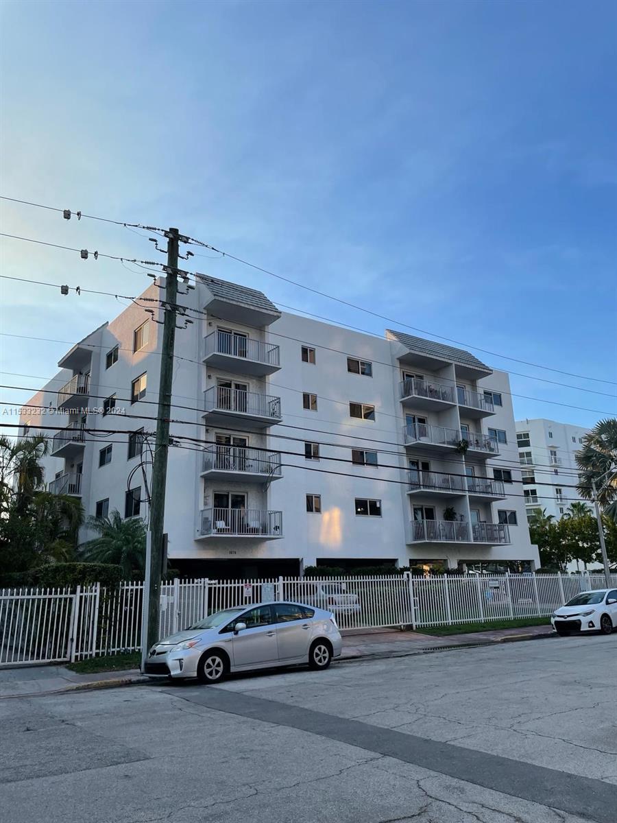 a front view of a building with parking space