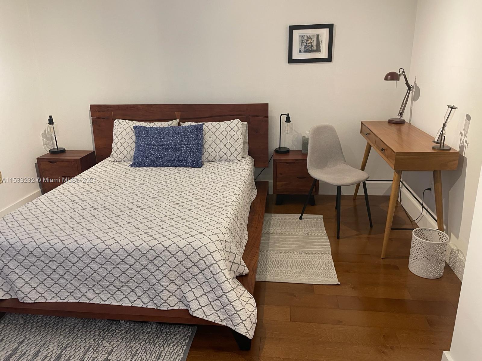 1674 Bay Road, Unit 402 Miami Beach, FL 33139 - Photo 11 of 16 a bedroom with a bed and a chair