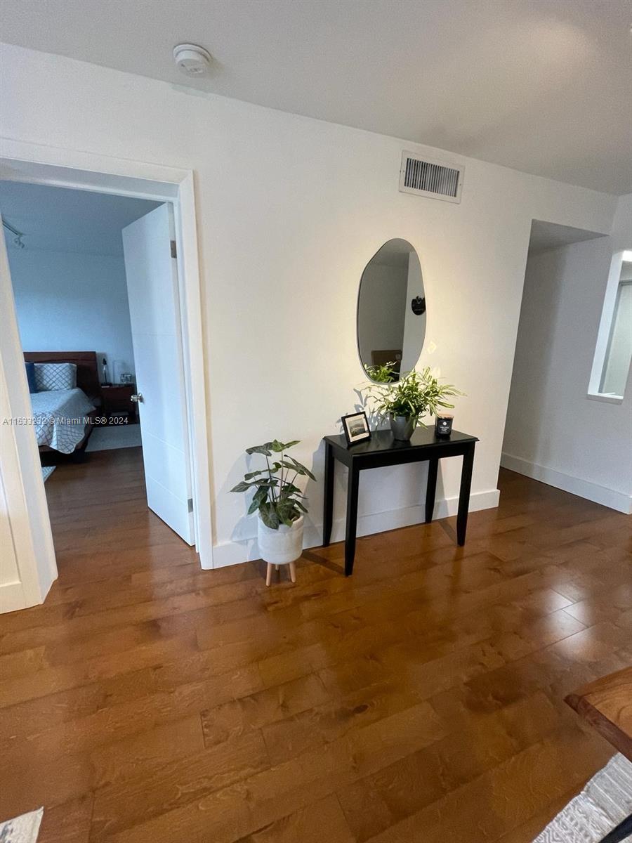 1674 Bay Road, Unit 402 Miami Beach, FL 33139 - Photo 12 of 16 a view of a livingroom with furniture and a floor to ceiling window
