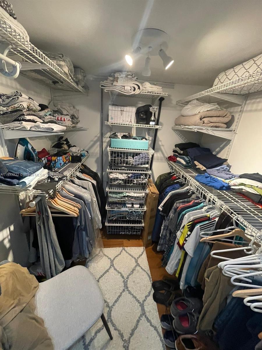 1674 Bay Road, Unit 402 Miami Beach, FL 33139 - Photo 13 of 16 a view of walk in closet with clothes and shoes