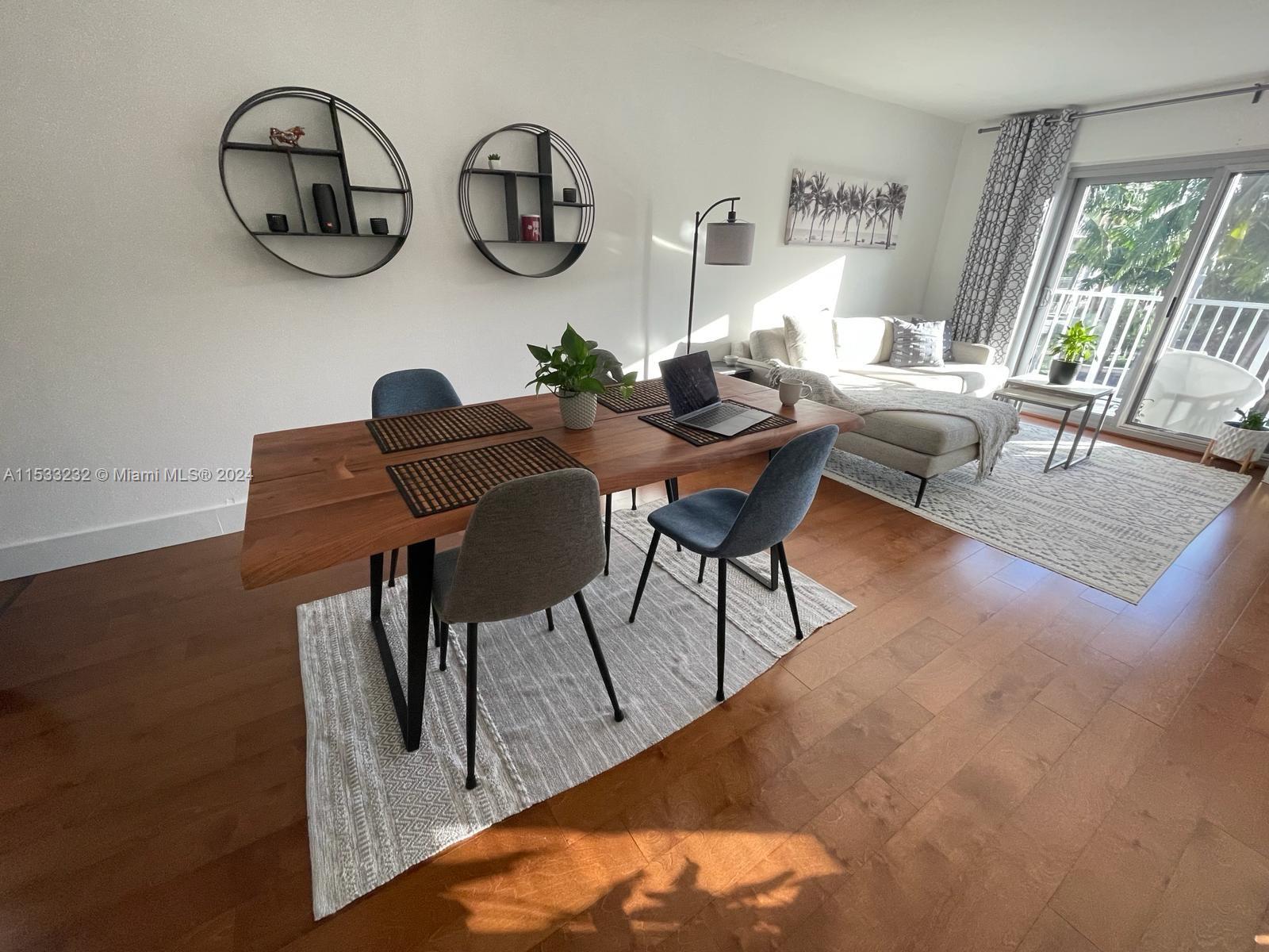 1674 Bay Road, Unit 402 Miami Beach, FL 33139 - Photo 3 of 16 a view of a dining room with furniture window and hardwood