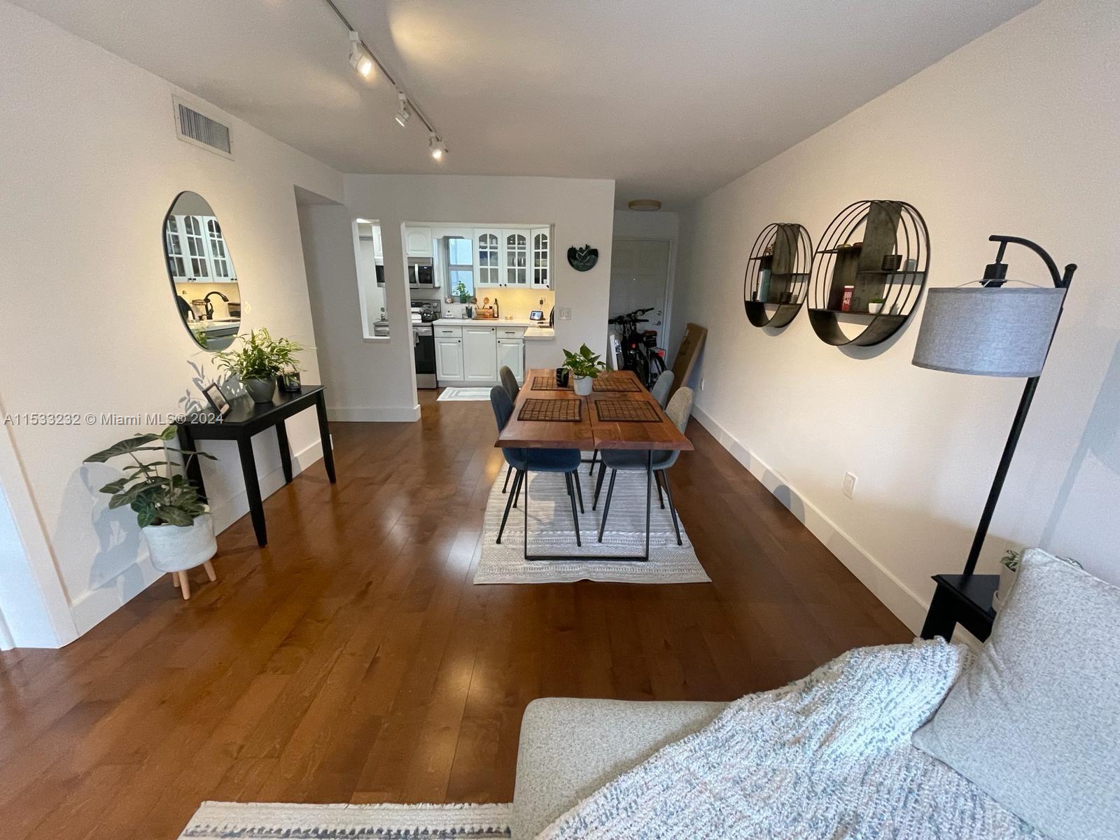 1674 Bay Road, Unit 402 Miami Beach, FL 33139 - Photo 4 of 16 a bedroom with furniture and a wooden floor