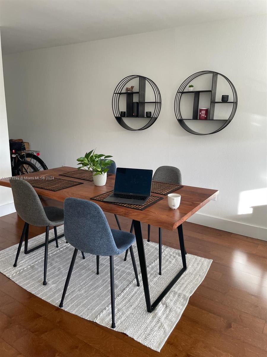 1674 Bay Road, Unit 402 Miami Beach, FL 33139 - Photo 5 of 16 a workspace room with furniture and wooden floor