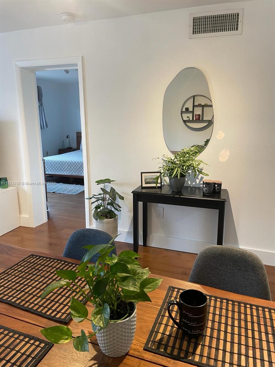 1674 Bay Road, Unit 402 Miami Beach, FL 33139 - Photo 9 of 16 a living room with a couch and chandelier