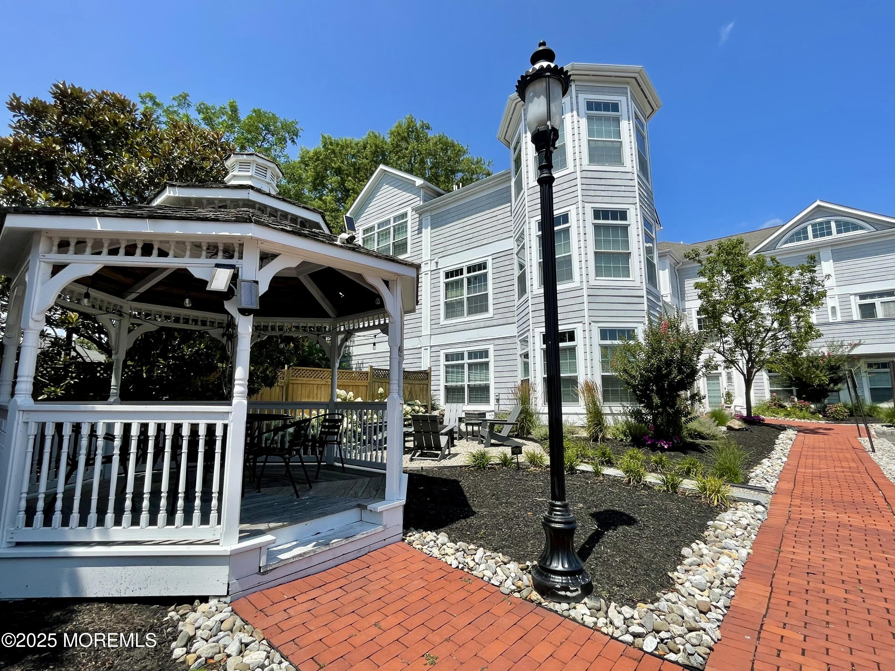 162 Main Street Manasquan, NJ 08736 - Photo 20 of 48 a front view of house with yard outdoor seating and barbeque oven