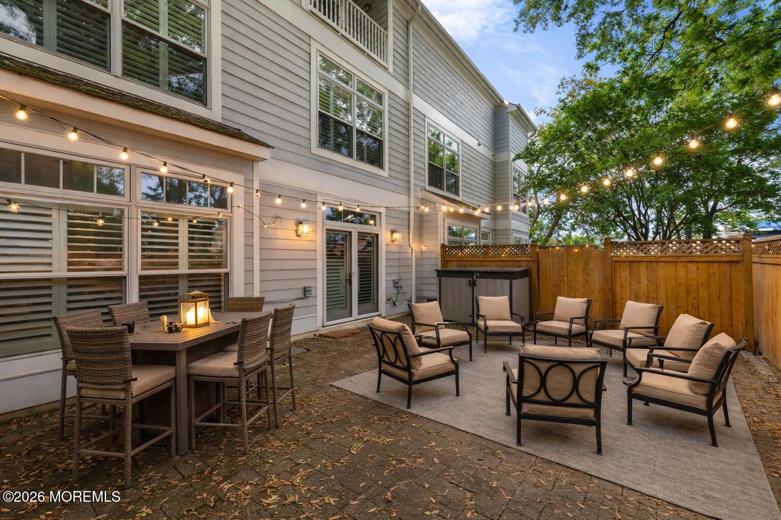162 Main Street Manasquan, NJ 08736 - Photo 26 of 41 Twilight patio retreat with wicker dinin
