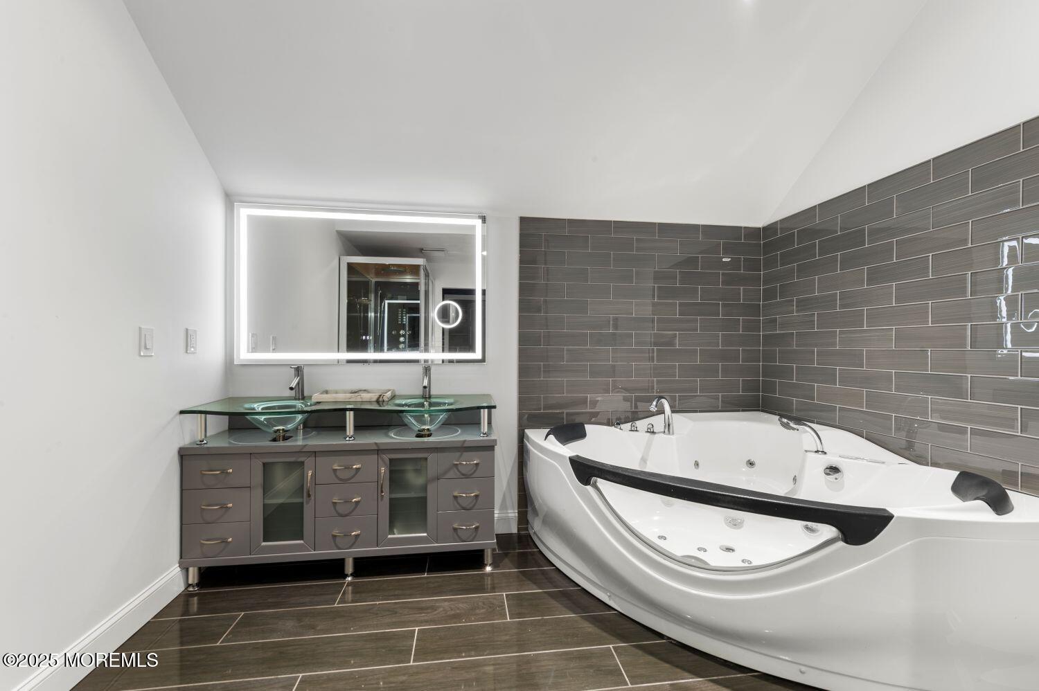 162 Main Street Manasquan, NJ 08736 - Photo 28 of 48 a bathroom with a granite countertop toilet sink and mirror