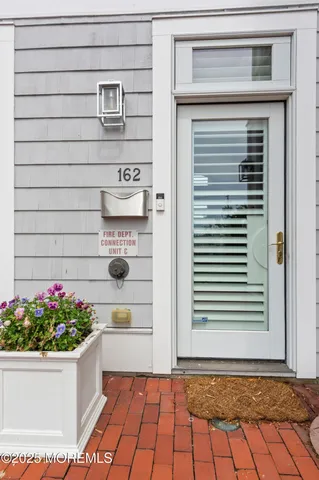 a front view of a house with a potted plant