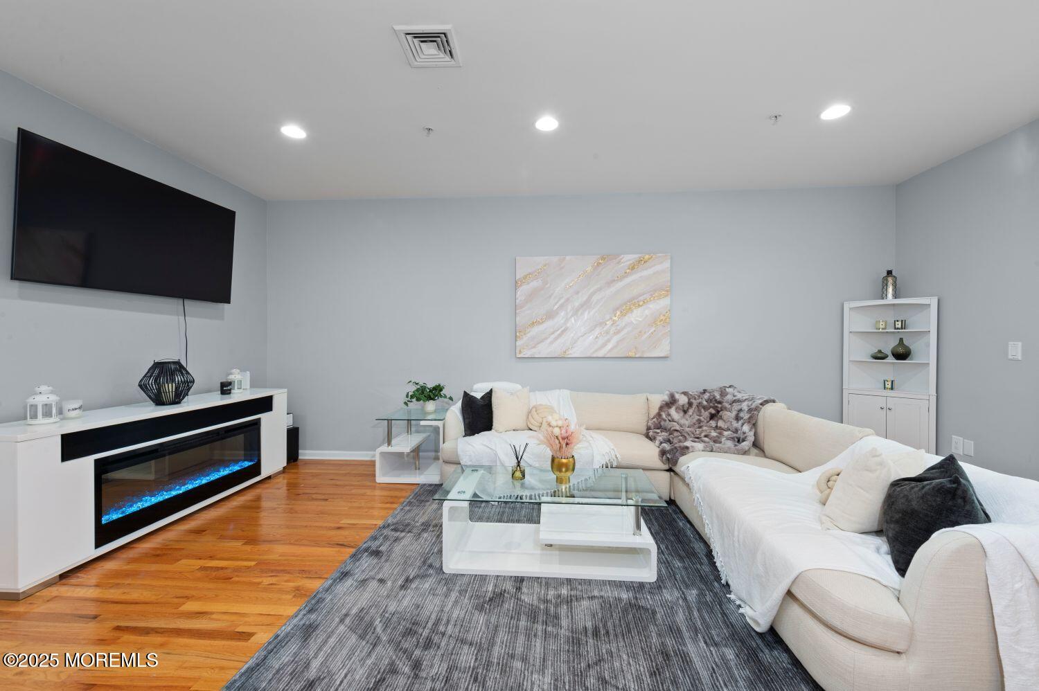 162 Main Street Manasquan, NJ 08736 - Photo 3 of 48 a living room with furniture and a flat screen tv