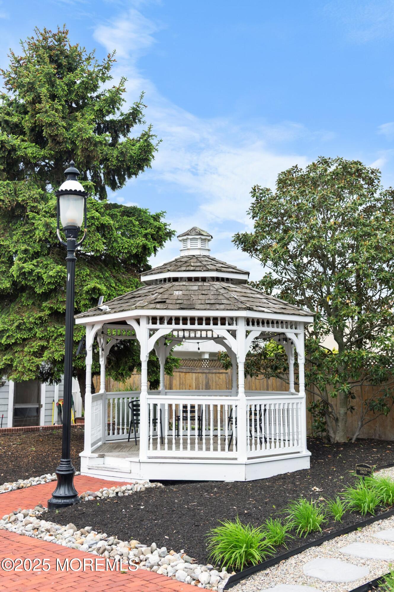 162 Main Street Manasquan, NJ 08736 - Photo 32 of 48 front view of a house with a garden