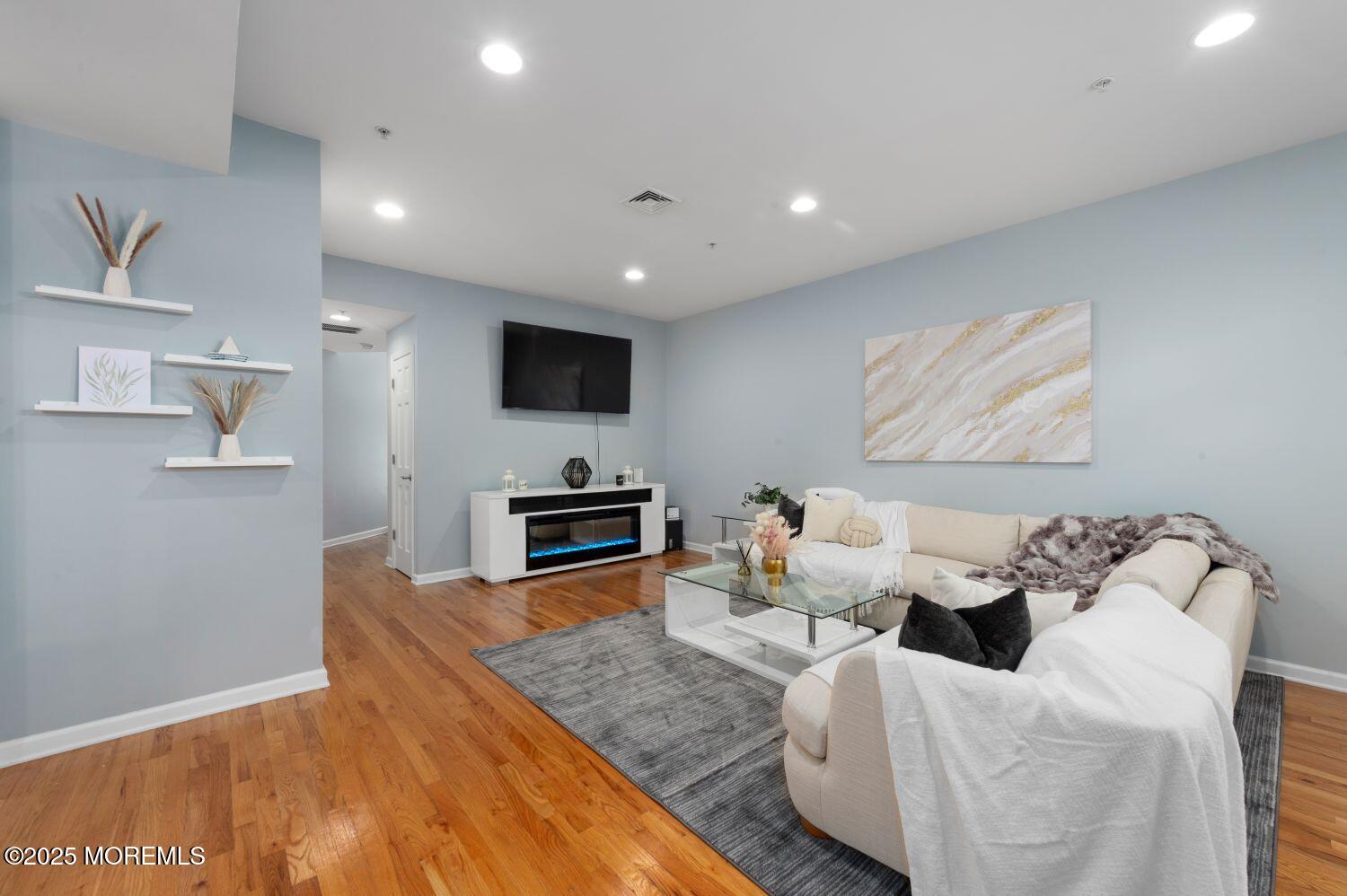 162 Main Street Manasquan, NJ 08736 - Photo 4 of 48 a living room with furniture a fireplace and a flat screen tv