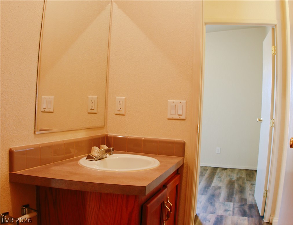 5231 Ruby Way Caliente, NV 89008 - Photo 27 of 35 Functional vanity and mirror create an efficient bathroom space, offering practical amenities.