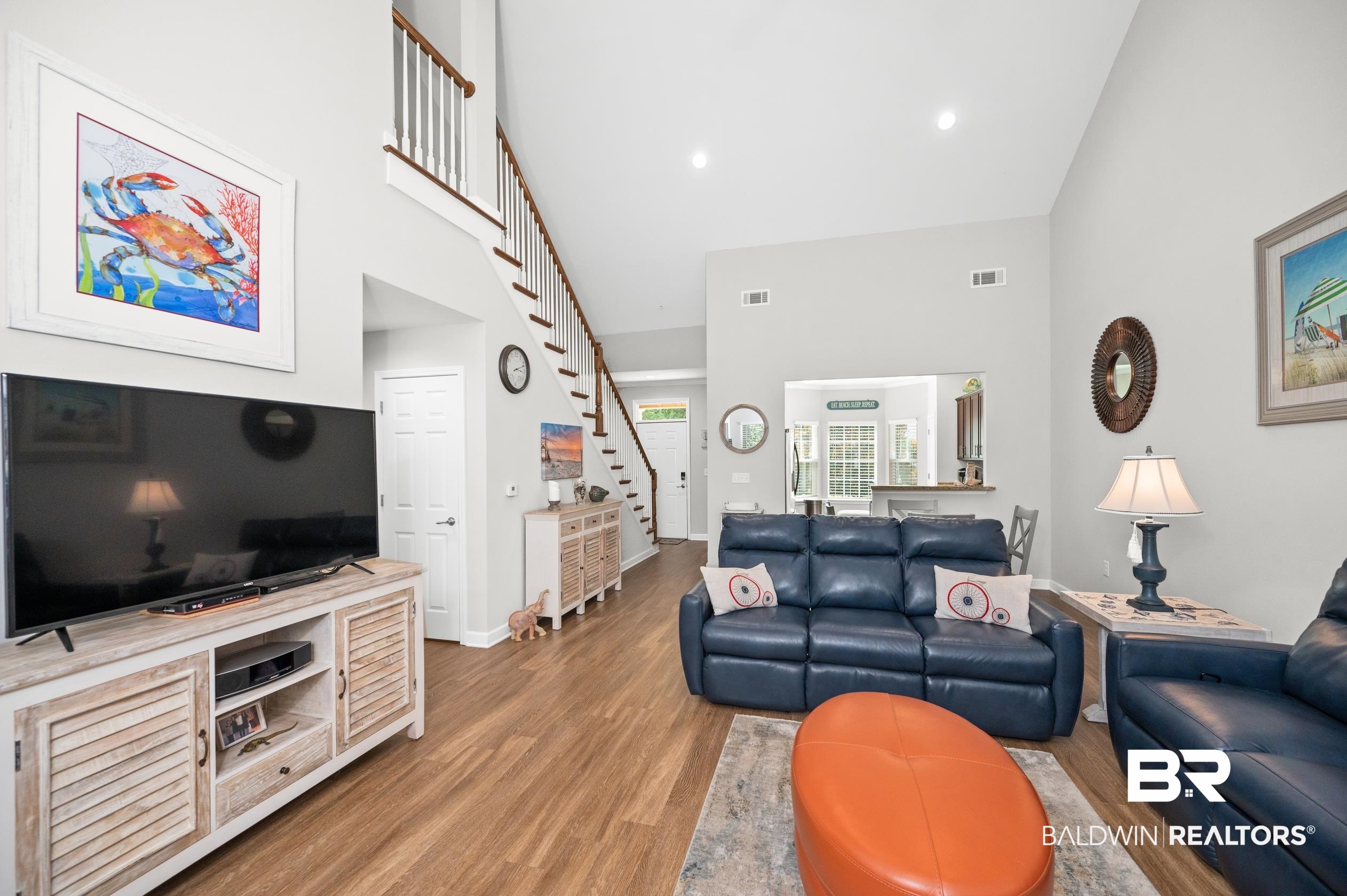 430 West Fort Morgan Road, Unit 1902 Gulf Shores, AL 36542 - Photo 8 of 59 Living room featuring wood-type flooring and a towering ceiling