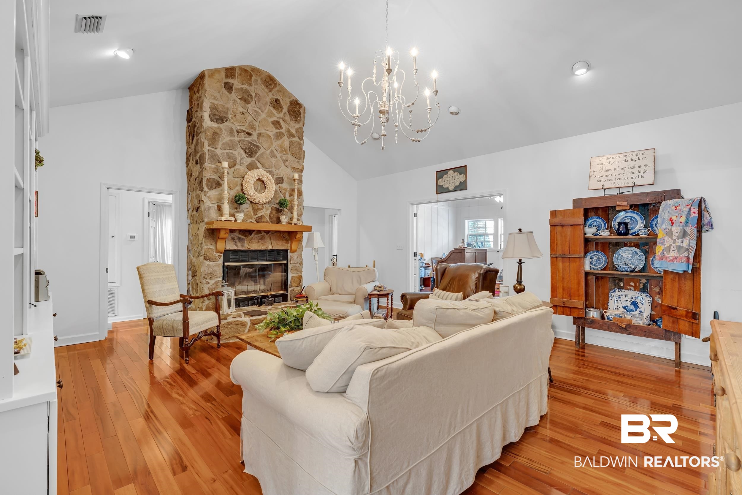 2 Navy Lane Daphne, AL 36527 - Photo 14 of 28 Living area featuring light wood-style flooring, a stone fireplace, high vaulted ceiling, and a chandelier
