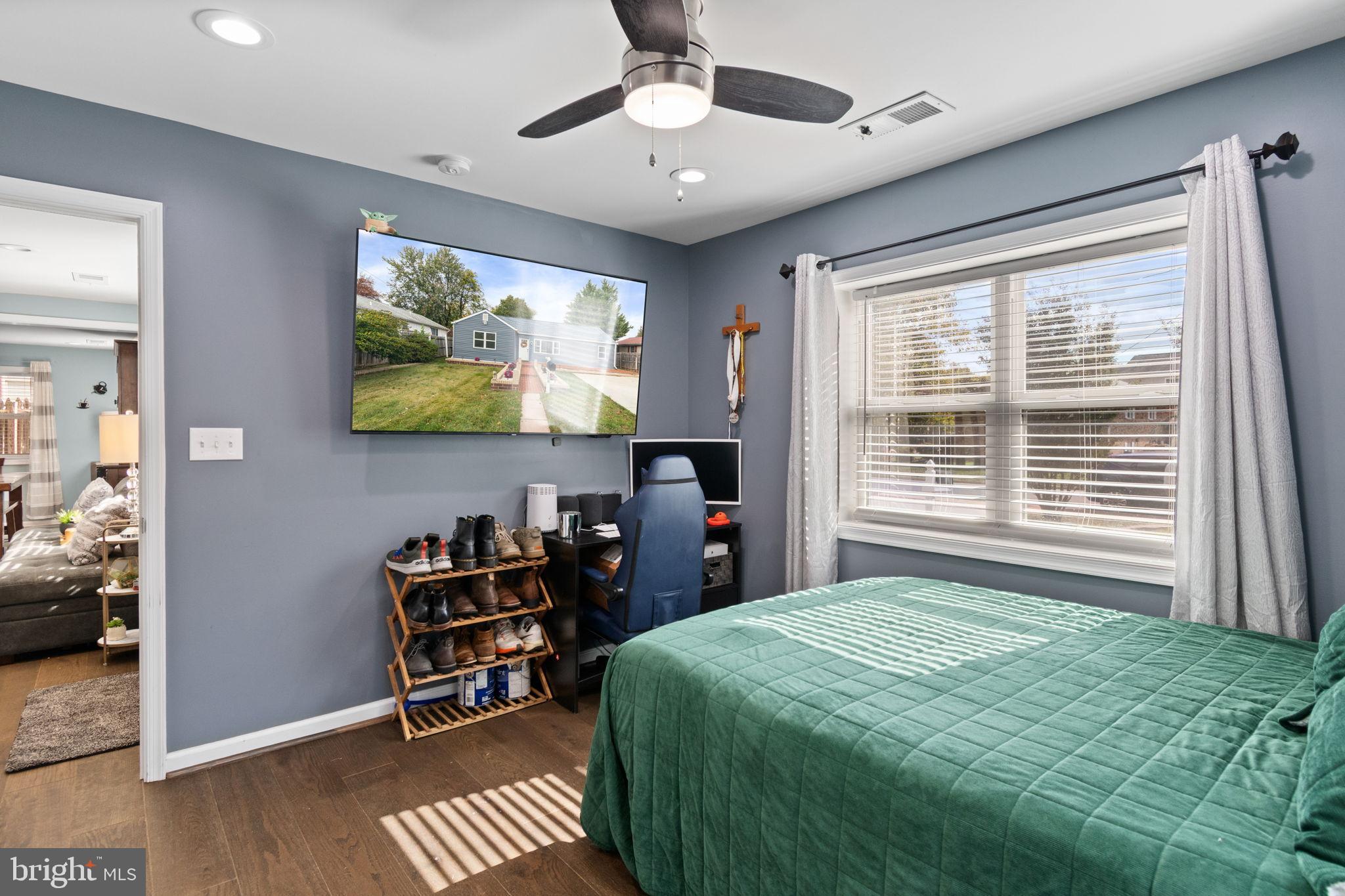 608 Blue Ridge Avenue Northeast Leesburg, VA 20176 - Photo 14 of 36 a bedroom with a bed and a flat screen tv