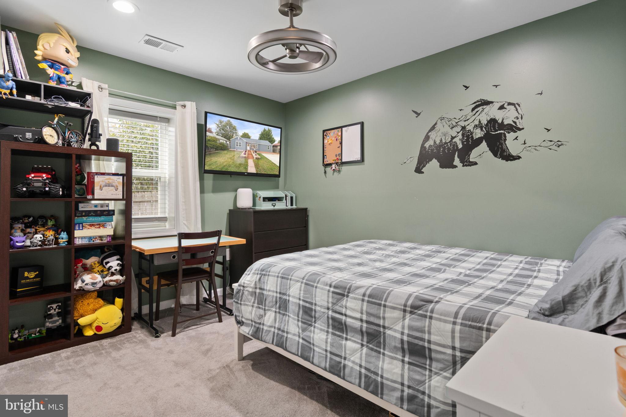 608 Blue Ridge Avenue Northeast Leesburg, VA 20176 - Photo 17 of 36 a bedroom with a bed and a bookshelf