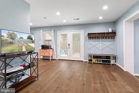 a view of workspace with furniture and wooden floor