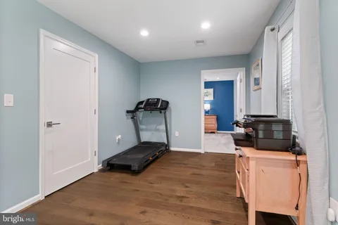 a view of a room with wooden floor and furniture