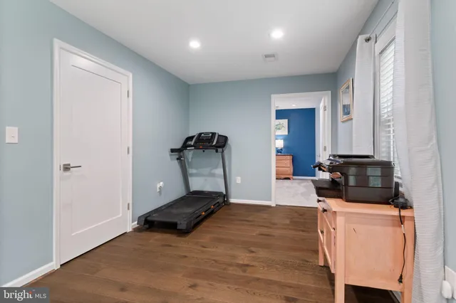 a view of a room with wooden floor and furniture