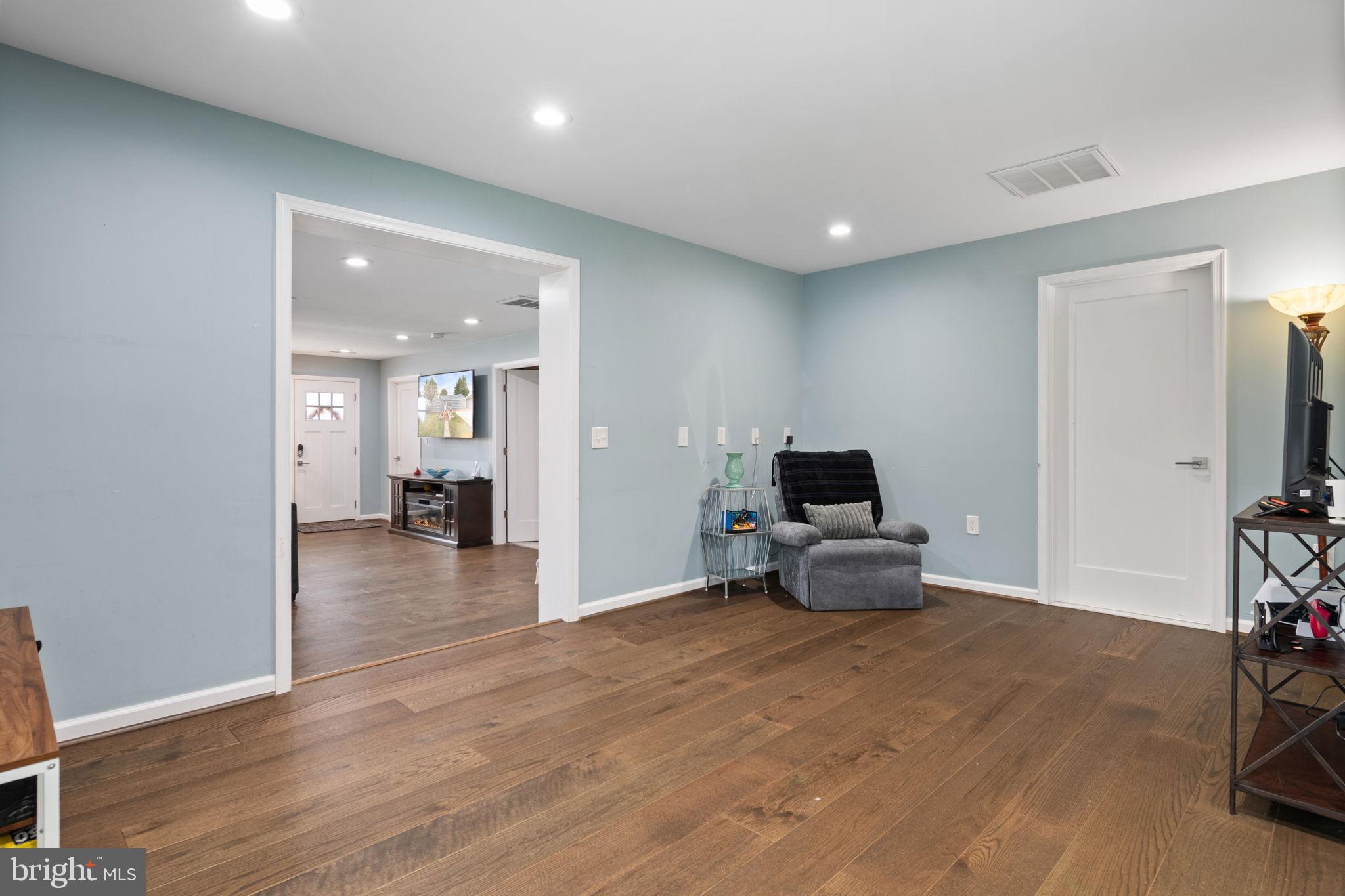 608 Blue Ridge Avenue Northeast Leesburg, VA 20176 - Photo 21 of 36 a living room with furniture and a flat screen tv