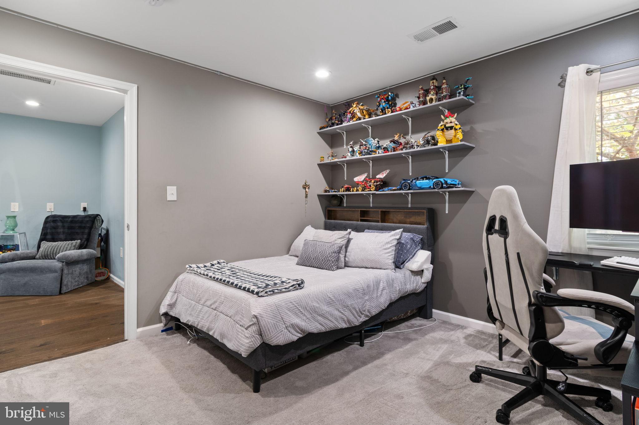 608 Blue Ridge Avenue Northeast Leesburg, VA 20176 - Photo 25 of 36 a bedroom with a bed a couch and a window