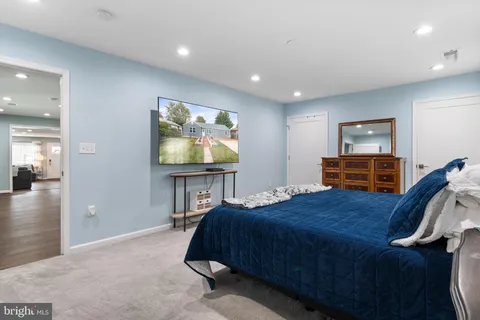 a bedroom with a bed and a flat screen television