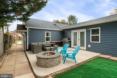 a swimming pool with outdoor seating and yard