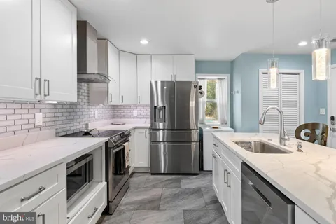 a kitchen with a sink stove and refrigerator