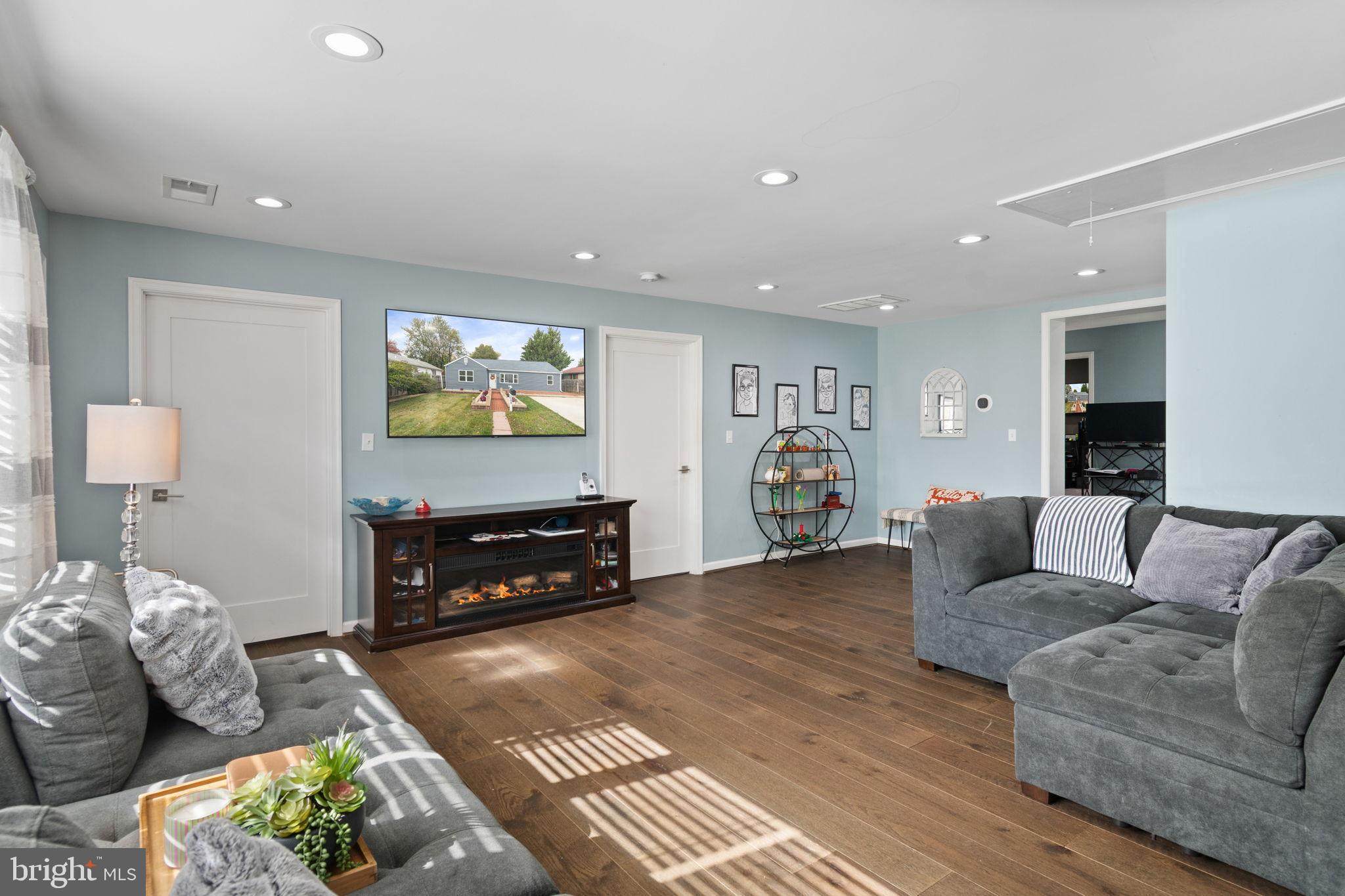 608 Blue Ridge Avenue Northeast Leesburg, VA 20176 - Photo 6 of 36 a living room with furniture and a flat screen tv