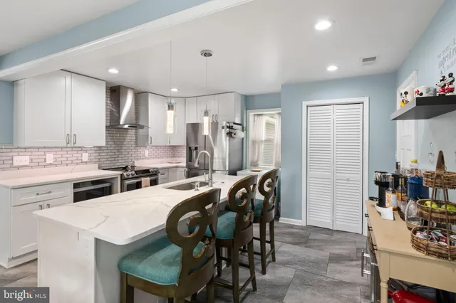 a kitchen with a table chairs stove and cabinets