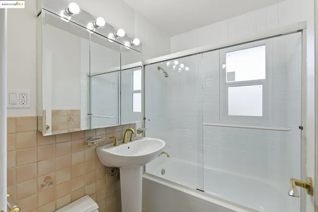 a bathroom with a sink a mirror and a shower