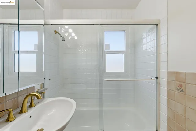 a bathroom with a sink and shower
