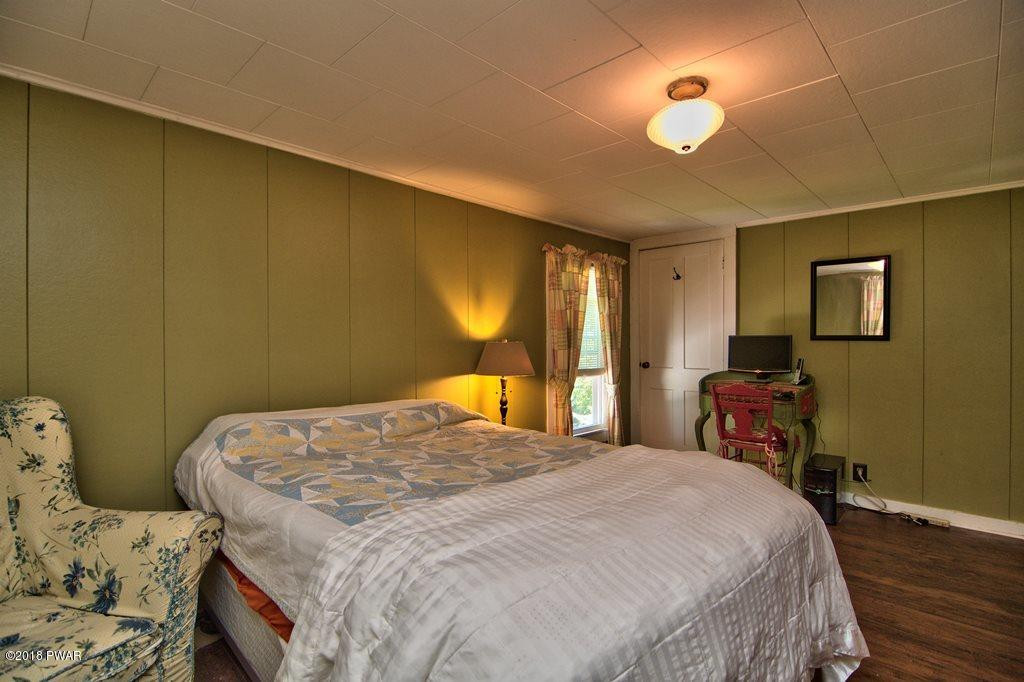 72 Hemlock Road Lake Ariel, PA 18436 - Photo 40 of 48 a bedroom with a bed and a chandelier