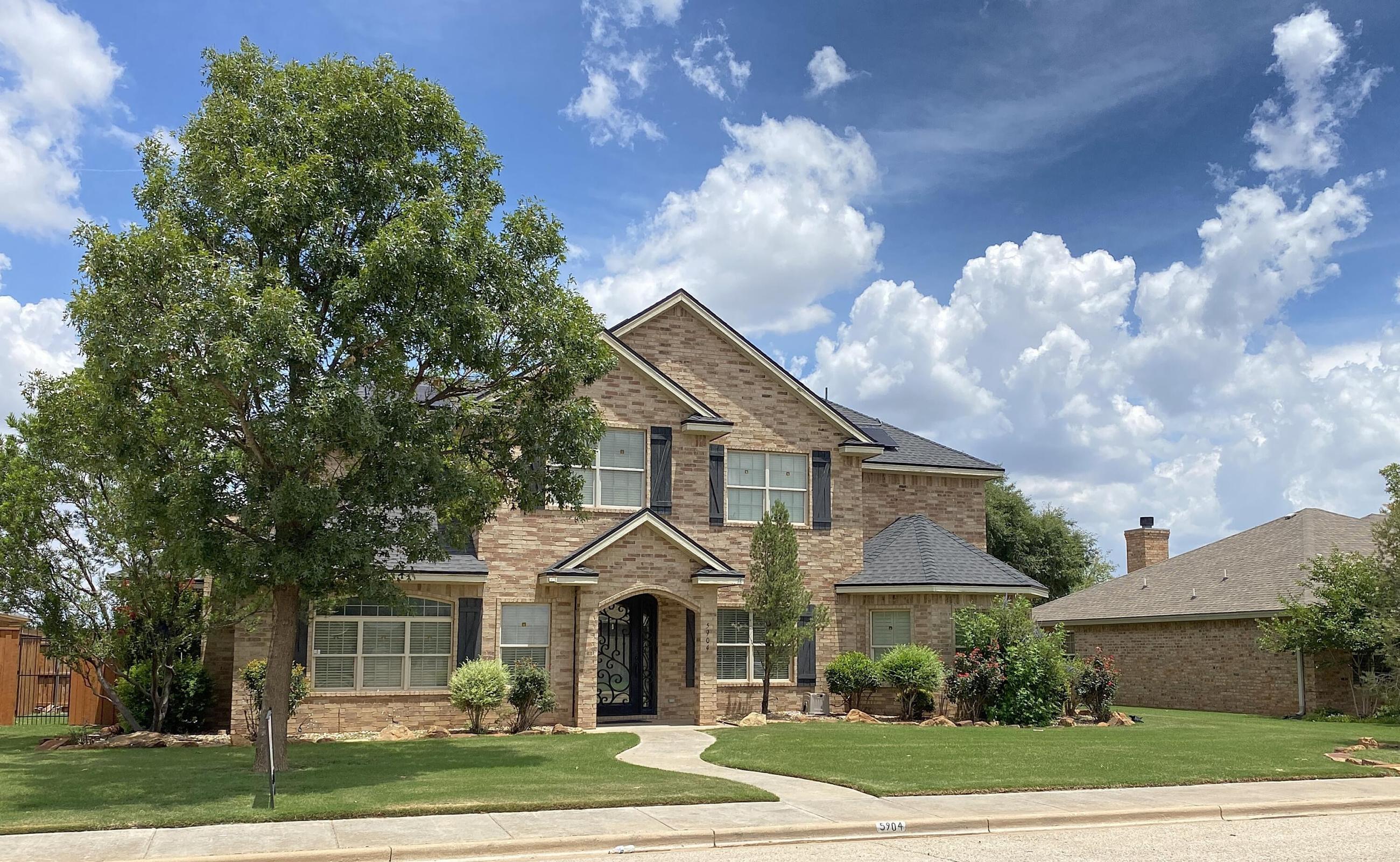 5904 110th Street Lubbock, TX 79424 - Photo 1 of 32 a front view of a house with garden