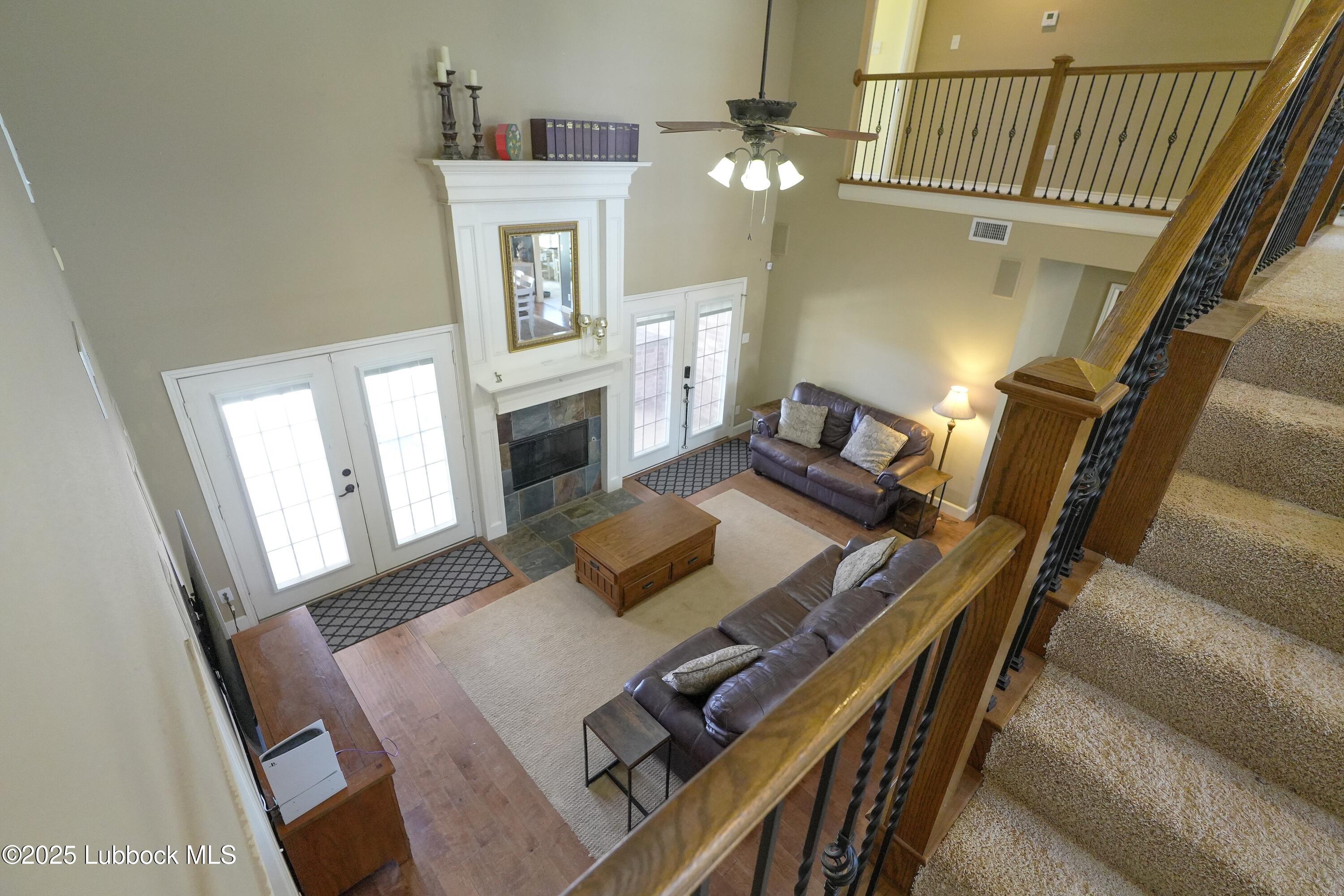 5904 110th Street Lubbock, TX 79424 - Photo 19 of 32 a living room with furniture and a fireplace