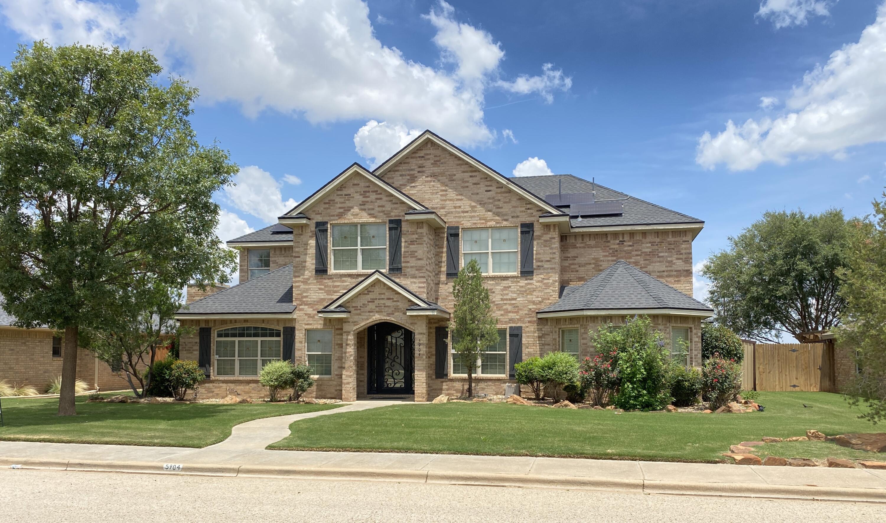 5904 110th Street Lubbock, TX 79424 - Photo 2 of 32 a front view of a house with a yard