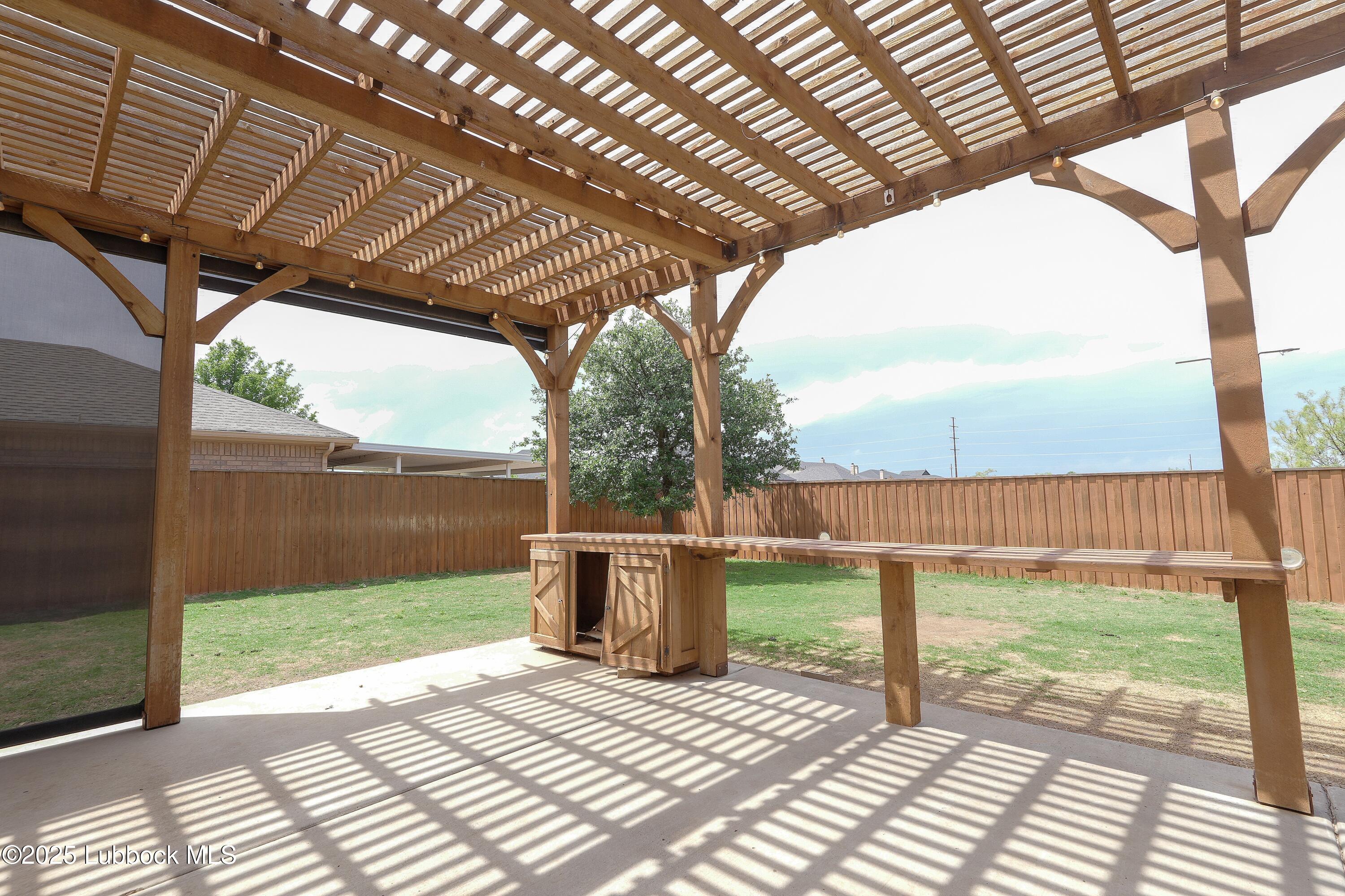 5904 110th Street Lubbock, TX 79424 - Photo 31 of 32 a view of a backyard with wooden floor and iron stairs