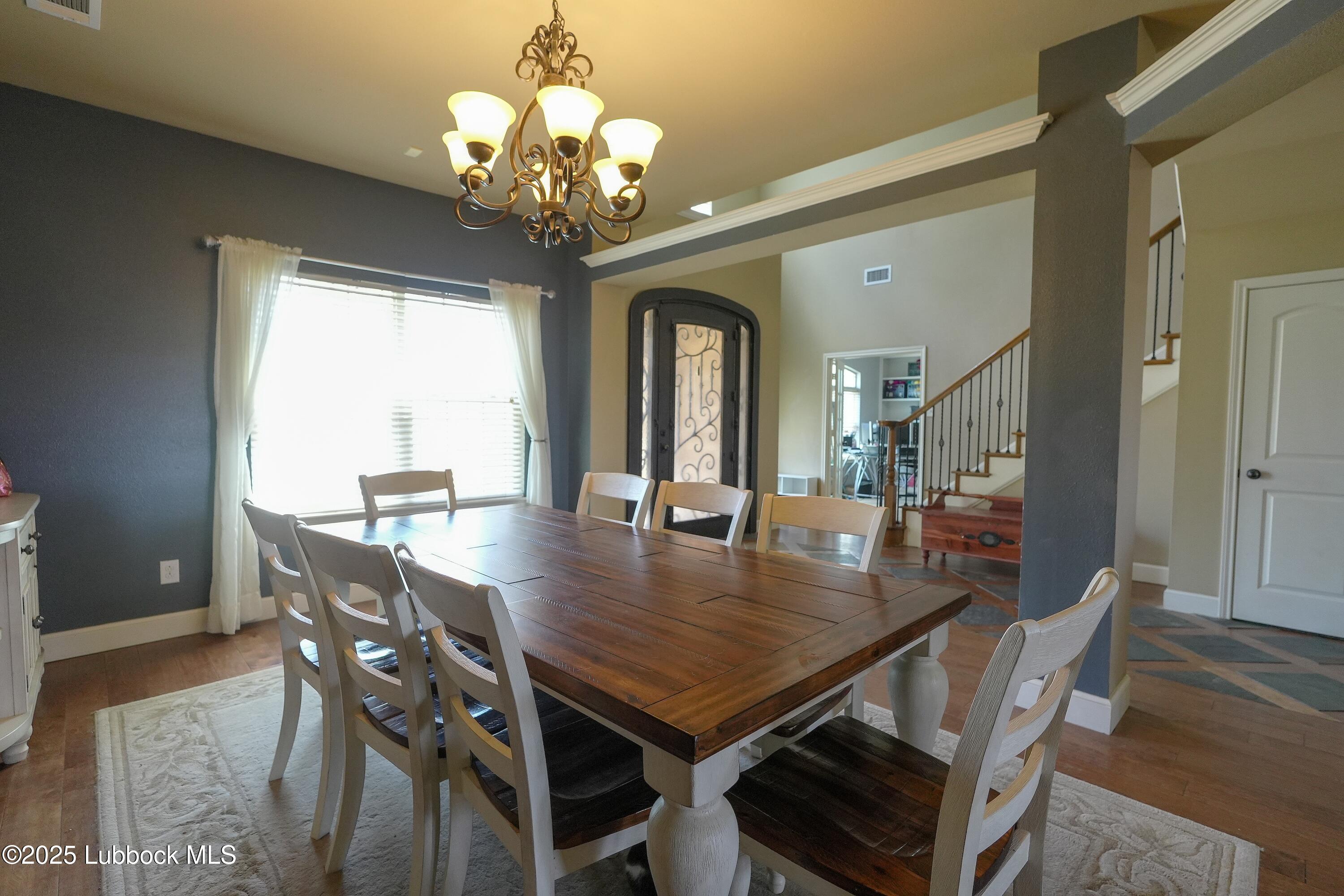 5904 110th Street Lubbock, TX 79424 - Photo 6 of 32 a view of a dining room with furniture window and wooden floor